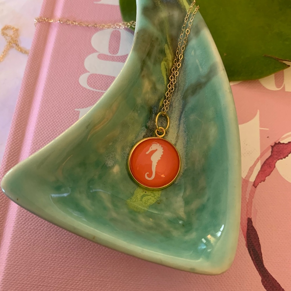Gold necklace and seahorse pendant